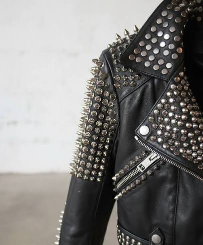 Men’s leather studded jacket in black genuine leather with punk biker styling, silver studs and edgy slim-fit design.